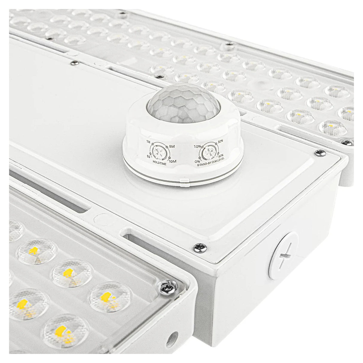 Close-up of a white linear high bay light with motion sensor and adjustable controls