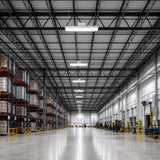 1.7FT LED linear high bay 310W illuminating industrial warehouse aisle with pallet racks and forklifts, 46500lm