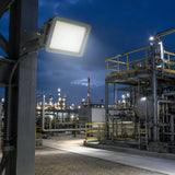 100W C1D2 explosion proof square flood light illuminating an outdoor refinery work area.