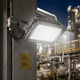 150W Class 1 Division 2 LED explosion proof flood light illuminating an industrial oil and gas plant at night.