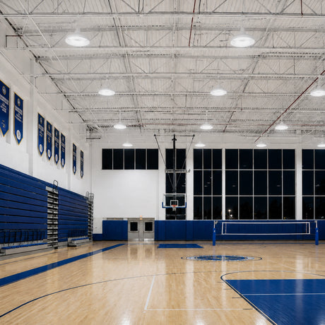 150W 21,900lm 5000K 120-277V 0-10V dimmable PC lens UFO LED high bay lights illuminate a gym.