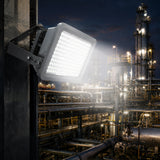 200W explosion proof LED flood light delivering 26,000 lumens of 5000K illumination across a refinery at night.