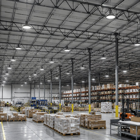 240W 36,240lm 5000K 277-480V UFO LED high bay lights illuminate a high-ceiling warehouse with pallet racks.