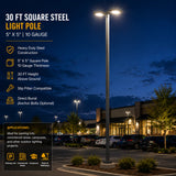 30 ft square steel light pole with 5x5 10 gauge construction in a parking lot at dusk