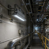 50W C1D1 explosion proof 1x2 linear light illuminating an industrial catwalk and piping area