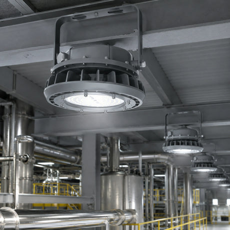 80W Class I Division II round LED high bay light illuminating a chemical processing factory interior.