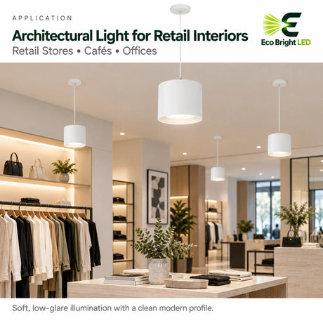 White 9 inch LED cylinder downlights with soft low-glare illumination in a modern retail store interior