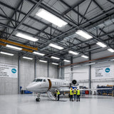 LED linear high bay lights illuminating a large aircraft hangar with workers and private jet inside