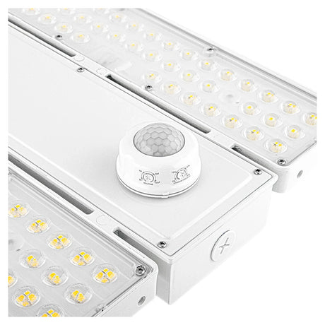 Linear LED high bay light with sensor and clear lens, showing selectable wattage and dimmable industrial design