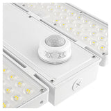 White linear high bay light with selectable LED panels and a motion sensor for industrial spaces