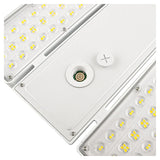 Close-up of a white linear high bay LED fixture with selectable wattage and clear lens panels